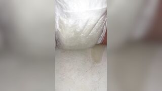 Chick fills up diaper with urinate until it overflows out the side