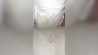Chick fills up diaper with urinate until it overflows out the side