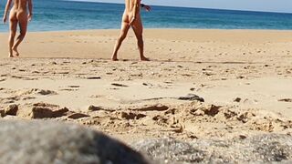 Fitness pair disrobe on a public beach and masturbate with people watching