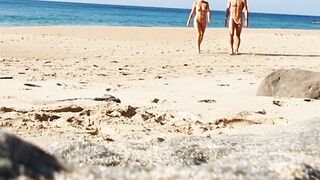 Fitness pair disrobe on a public beach and masturbate with people watching