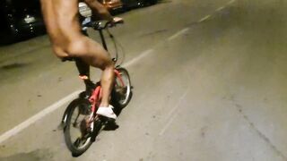 Hot chap disrobes on a public street and rides a bike nude touching his weenie - risky