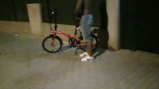 Hot chap disrobes on a public street and rides a bike nude touching his weenie - risky