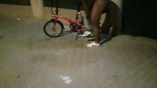 Hot chap disrobes on a public street and rides a bike nude touching his weenie - risky