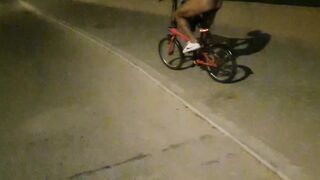 Hot chap disrobes on a public street and rides a bike nude touching his weenie - risky
