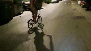 Hot chap disrobes on a public street and rides a bike nude touching his weenie - risky
