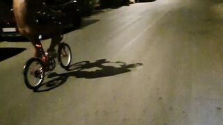 Hot chap disrobes on a public street and rides a bike nude touching his weenie - risky