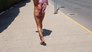 Sexy gal walking strips on a public street and shows off her cunt