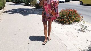 Sexy gal walking strips on a public street and shows off her cunt