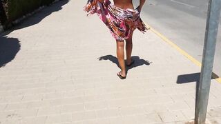 Sexy gal walking strips on a public street and shows off her cunt