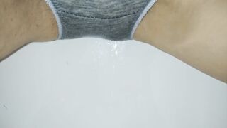 wetting: urinated in gray pants