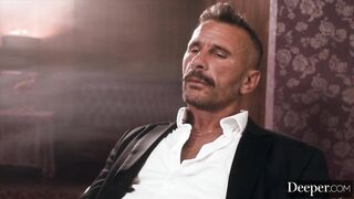 A cigar shop employee is at the service of an exacting customer.