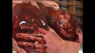 Breasty golden-haired enjoys sex with chocolate on her large breasts