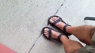 My hunk pedicured feet in sandals