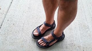 My hunk pedicured feet in sandals