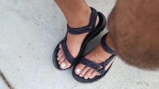 My hunk pedicured feet in sandals