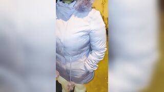 Aged woman wearing red thread in transparent leggings, captured on the street