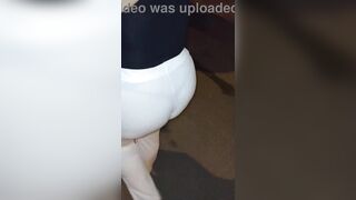 Aged woman wearing red thread in transparent leggings, captured on the street