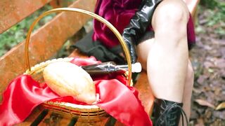 Little Red Riding Hood walking alone in the forest