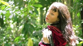 Little Red Riding Hood walking alone in the forest