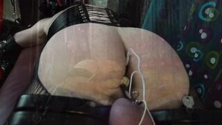 Boy slavery serf in the electro humbler with anal shock plug paddled on the slavery table
