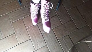 Sitting on a chair in hose and high heeled boots