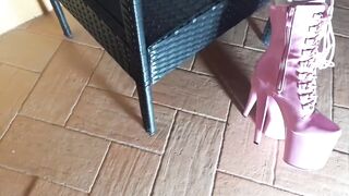 Sitting on a chair in hose and high heeled boots