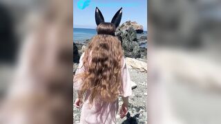 Tiny princess teases on a public beach in advance of sex