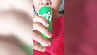 Chap enjoying a sprite, licking and smacking lips