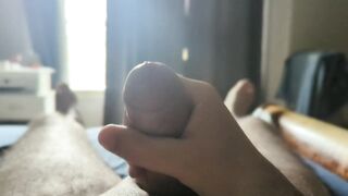 Masturbating with some sun rays throughout the window