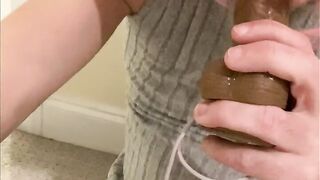 Sissy Crossdresser in constricted costume and haunch high nylons with jock sleeve sheath pants shows off and sucks on a large sex toy