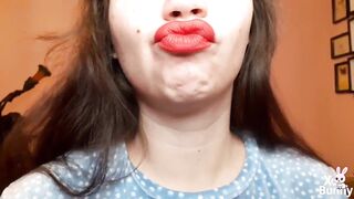 Natural lips with red lipstick smokin' a cigarette in close up