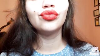 Natural lips with red lipstick smokin' a cigarette in close up