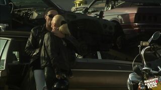 This unattractive junkyard was filled with ancient automobiles, necessitating their engagement in raunchy activity on one.