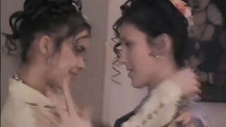 Oksana fooling around with her friend to the sound of the TV