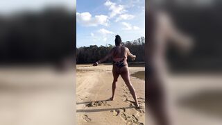 BLACK COUGAR TWERKING ON THE BEACH IN A SWIMSUIT