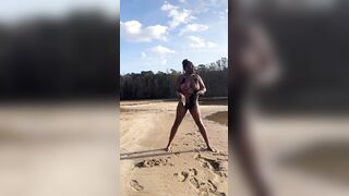 BLACK COUGAR TWERKING ON THE BEACH IN A SWIMSUIT