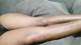 A Woman with Tons of Charming Pubic Hair Between Her Legs Lies on Her Sofa Awaiting to Be Made Love to Her