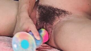 Playing with a large, thick sex-toy