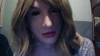 Masked in Anine female mask with pink wig and putting on ebony leather gloves!