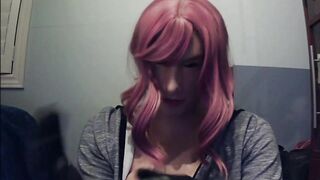 Masked in Anine female mask with pink wig and putting on ebony leather gloves!