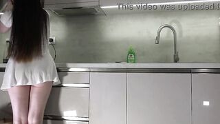 Fresh wife sexy brunette hair chick with large bazookas large booty in the kitchen with a short white transparent costume shows what this babe has