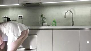 Fresh wife sexy brunette hair chick with large bazookas large booty in the kitchen with a short white transparent costume shows what this babe has