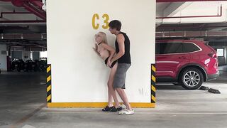 Unknown blond bangs in a parking lot in plain sight