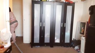 big beautiful woman SSBBW abode chores in suspenders & strap