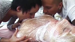 Plastic Wrapped Aged Bitch Licked and Facesat by Lascivious Pair