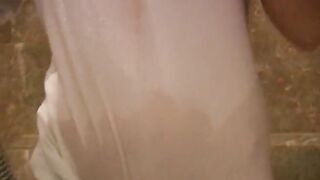 Breasty golden-haired wearing shirt during the time that taking a shower