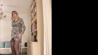Nice-looking Spanish trans woman positions seductively in the living room wearing high red heels and a hawt suit