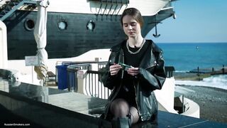 Youthful Russian Woman Smokin' Cigarette Outdoor Terrace