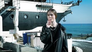 Youthful Russian Woman Smokin' Cigarette Outdoor Terrace