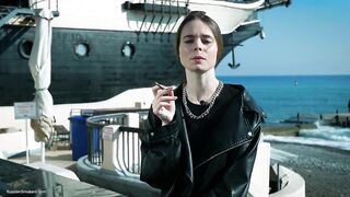 Youthful Russian Woman Smokin' Cigarette Outdoor Terrace